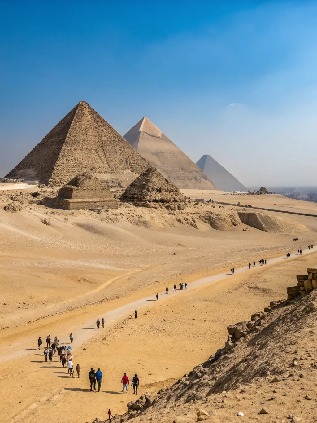 A stunning photograph of the pyramids of Giza, Egypt, set against a clear blue sky, representing African destinations served by Milajet Havacilik.